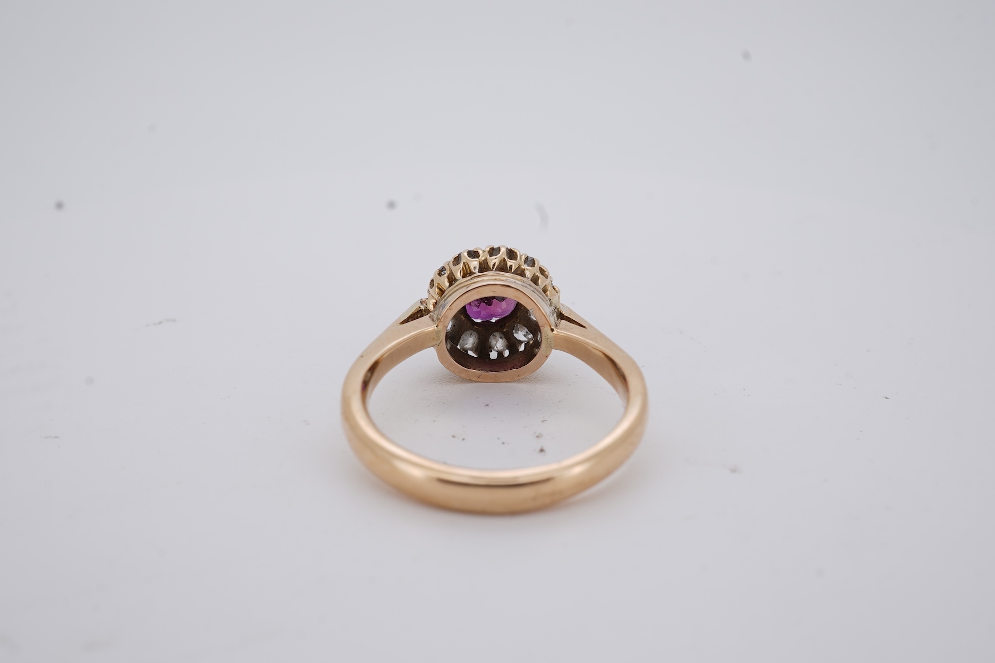 A George V 18ct gold, ruby and diamond set circular cluster ring, size M, gross weight 5 grams.